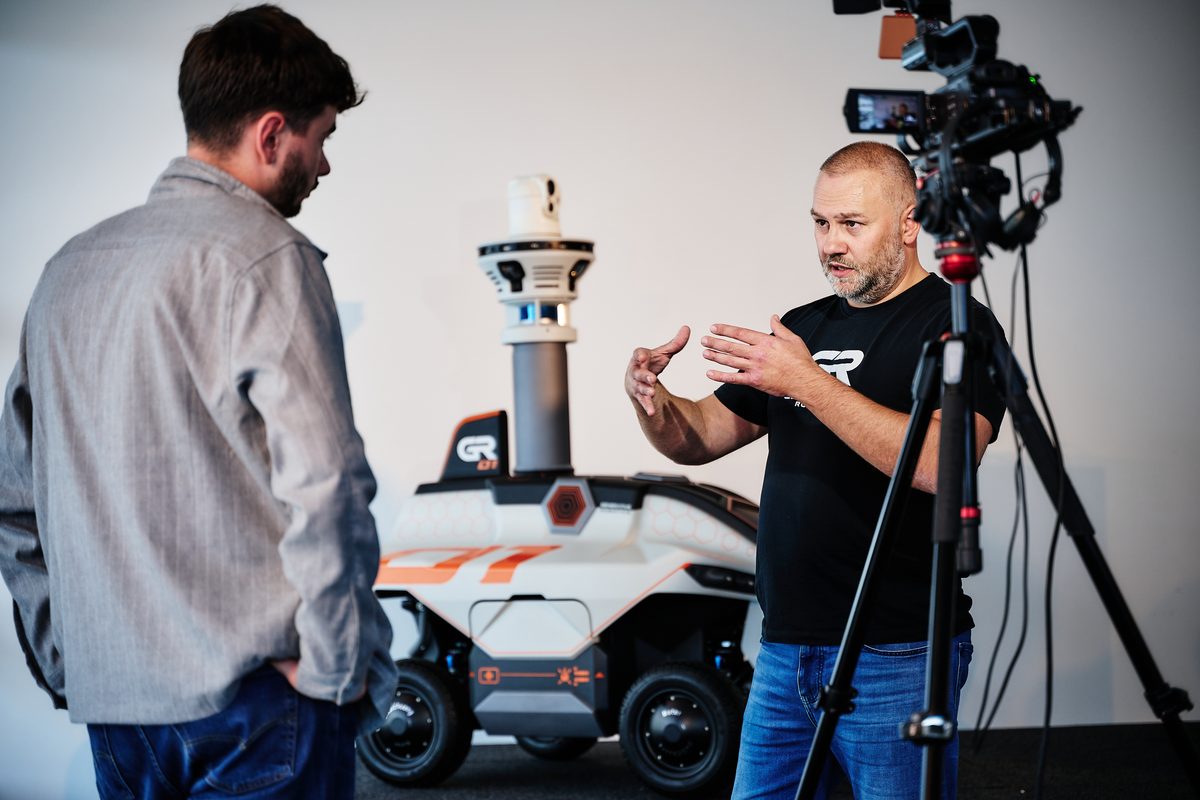 Conversation in front of the camera, GR-01 in the background